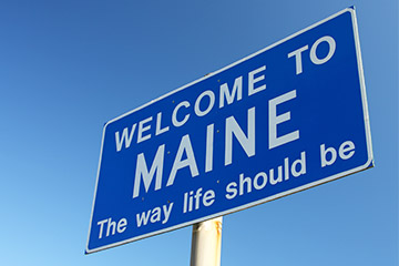 Blue welcome to main road sign